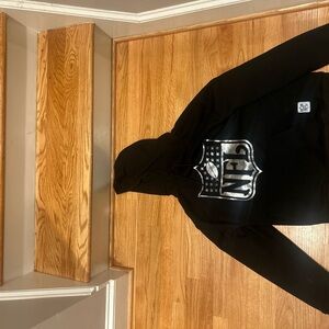 NFL Black Hoodie with Shiny Silver Emblem